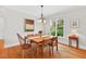 Dining room with hardwood floors, natural light, and stylish chandelier and tasteful decor at 8851 Mariner Dr, Raleigh, NC 27615