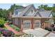 Exterior showcasing a brick home with attached garage and beautiful landscaping with a brick lined walkway at 8851 Mariner Dr, Raleigh, NC 27615