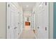 Hallway with multiple white doors and views into other rooms at 8851 Mariner Dr, Raleigh, NC 27615