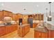 This kitchen boasts hardwood floors, granite countertops, stainless steel appliances, and wood cabinets at 8851 Mariner Dr, Raleigh, NC 27615
