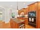 Gourmet kitchen with island, granite countertops, wood cabinets, and stainless steel appliances at 8851 Mariner Dr, Raleigh, NC 27615