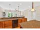 Kitchen featuring granite countertops, wood cabinets, an island and a breakfast bar at 8851 Mariner Dr, Raleigh, NC 27615