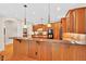 Kitchen with a breakfast bar, granite countertops, wood cabinets and hardwood floors at 8851 Mariner Dr, Raleigh, NC 27615