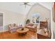 Sunlit living room with hardwood floors, a vaulted ceiling, and large arched window at 8851 Mariner Dr, Raleigh, NC 27615