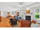 Bright and airy living room with hardwood floors, fireplace, and access to dining and sunroom at 8851 Mariner Dr, Raleigh, NC 27615