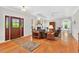 Spacious living room with hardwood floors, fireplace, tray ceiling, and ample natural light at 8851 Mariner Dr, Raleigh, NC 27615