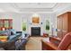 Inviting living room with fireplace, hardwood floors, and a view of the front door and backyard at 8851 Mariner Dr, Raleigh, NC 27615