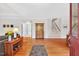 Inviting living room with hardwood floors, staircase, and view of the home's front door at 8851 Mariner Dr, Raleigh, NC 27615