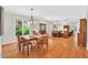 Open-concept living space featuring hardwood floors and a dining area connecting to a living room at 8851 Mariner Dr, Raleigh, NC 27615