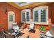 Relaxing brick patio with lounge chairs, throw pillows, and views of lush landscaping at 8851 Mariner Dr, Raleigh, NC 27615