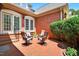 Beautiful brick patio with outdoor seating, landscaping, and a privacy hedge at 8851 Mariner Dr, Raleigh, NC 27615