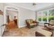 Comfortable sunroom with tile floors and wicker furniture, filled with natural light and garden view at 8851 Mariner Dr, Raleigh, NC 27615