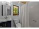 Clean bathroom with a shower/tub combo, vanity, and stylish fixtures and natural light at 9709 Greenfield Rd, Chapel Hill, NC 27516