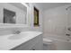 Bright bathroom featuring a white vanity, a window for natural light, and a tub with shower in a clean and modern style at 9709 Greenfield Rd, Chapel Hill, NC 27516