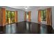 Bright, spacious bedroom featuring dark wood floors, large windows and a ceiling fan at 9709 Greenfield Rd, Chapel Hill, NC 27516