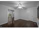 Bedroom featuring hardwood floors, a ceiling fan, and an open doorway to another room at 9709 Greenfield Rd, Chapel Hill, NC 27516