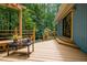 View of the deck with steps leading down, offering an outdoor area with views of the surrounding woods at 9709 Greenfield Rd, Chapel Hill, NC 27516