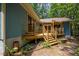 Outdoor deck area with wooden stairs, railings, and a partial view of the home's exterior at 9709 Greenfield Rd, Chapel Hill, NC 27516