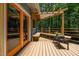 Deck with outdoor seating, a small table with plants, and views of the surrounding greenery at 9709 Greenfield Rd, Chapel Hill, NC 27516