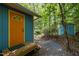 Exterior showcasing a colorful, inviting home in a natural setting with an orange front door at 9709 Greenfield Rd, Chapel Hill, NC 27516