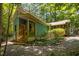 Charming blue and yellow home featuring a wooden porch and gravel driveway at 9709 Greenfield Rd, Chapel Hill, NC 27516