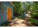 View of the property, featuring the shed, main house, and a path leading to both at 9709 Greenfield Rd, Chapel Hill, NC 27516