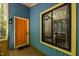 Inviting front porch with a colorful door, large window, and wood flooring offering a warm welcome at 9709 Greenfield Rd, Chapel Hill, NC 27516