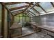 Interior view of a greenhouse with tables for plant display and cultivation, complete with a heating system at 9709 Greenfield Rd, Chapel Hill, NC 27516