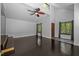 Bright living room features dark hardwood floors, large windows, and a high ceiling at 9709 Greenfield Rd, Chapel Hill, NC 27516