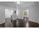 Bright living room with hardwood floors, and multiple entryways into adjacent rooms at 9709 Greenfield Rd, Chapel Hill, NC 27516