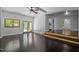Open living room featuring vaulted ceilings, hardwood floors, and access to an outdoor deck at 9709 Greenfield Rd, Chapel Hill, NC 27516