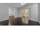 Living room with hardwood floors, and a sliding glass door leading to a screened-in porch at 9709 Greenfield Rd, Chapel Hill, NC 27516