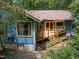 Rear exterior view of a home with a wooden deck and garden beds at 9709 Greenfield Rd, Chapel Hill, NC 27516