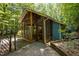 Enclosed screened porch with a wood frame design, offering an ideal space for outdoor relaxation and enjoying nature at 9709 Greenfield Rd, Chapel Hill, NC 27516