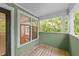 A balcony with green walls and a view of a lush green space at 1010 Nicholwood Dr # 301, Raleigh, NC 27605