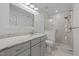 Elegant bathroom with marble vanity, framed mirror, and a glass-enclosed shower with modern fixtures at 1010 Nicholwood Dr # 301, Raleigh, NC 27605