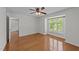 Bright bedroom with hardwood floors and a large window, featuring ceiling fan and neutral walls at 1010 Nicholwood Dr # 301, Raleigh, NC 27605