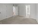 A bedroom featuring neutral carpet and white walls, with an open doorway leading to the bathroom at 1010 Nicholwood Dr # 301, Raleigh, NC 27605