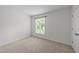Bright bedroom featuring neutral carpet, white walls, and a window offering natural light at 1010 Nicholwood Dr # 301, Raleigh, NC 27605