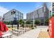 Outdoor area features picnic tables and seating near office and condo buildings, a great community gathering space at 1010 Nicholwood Dr # 301, Raleigh, NC 27605