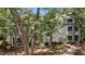 Exterior of condo building, showcasing unit numbers and surrounding greenery with mature trees at 1010 Nicholwood Dr # 301, Raleigh, NC 27605