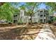 Green, multi-story condo building with mature trees in a well-maintained complex at 1010 Nicholwood Dr # 301, Raleigh, NC 27605