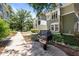 Exterior view of apartment homes and walkway with a charcoal grill in the foreground at 1010 Nicholwood Dr # 301, Raleigh, NC 27605