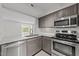 Modern kitchen boasts stainless steel appliances, granite countertops, and a pass-through window at 1010 Nicholwood Dr # 301, Raleigh, NC 27605