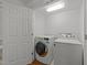 Convenient laundry room includes a modern washer, dryer, and plenty of storage space; well-lit and efficient at 1010 Nicholwood Dr # 301, Raleigh, NC 27605