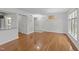 Open floor plan featuring hardwood floors and views of a kitchen area with granite countertops at 1010 Nicholwood Dr # 301, Raleigh, NC 27605