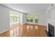 Living room with hardwood floors, fireplace, and lots of natural light from large windows at 1010 Nicholwood Dr # 301, Raleigh, NC 27605