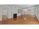 Spacious living area with hardwood floors, fireplace, and kitchen featuring granite counters at 1010 Nicholwood Dr # 301, Raleigh, NC 27605