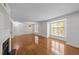 Living room with hardwood floors, fireplace, and large windows for natural light at 1010 Nicholwood Dr # 301, Raleigh, NC 27605