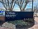 Village District sign with landscaping at 1010 Nicholwood Dr # 301, Raleigh, NC 27605